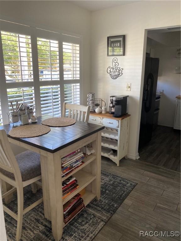 dining space with dark wood-type flooring