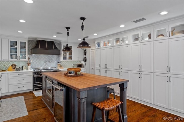 1035 N Appalachian Ter, Crystal River, FL 34429 - kitchen with wooden counters, custom range hood, beverage cooler, a breakfast bar area, and white cabinetry
