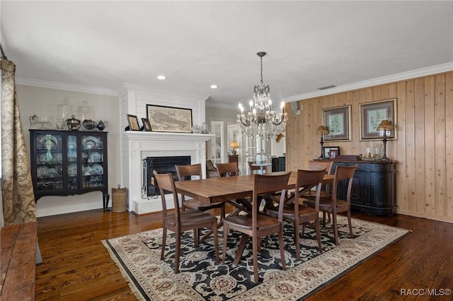 1035 N Appalachian Ter, Crystal River, FL 34429 - dining space with a fireplace with raised hearth, crown molding, dark wood-style flooring, a chandelier, and recessed lighting