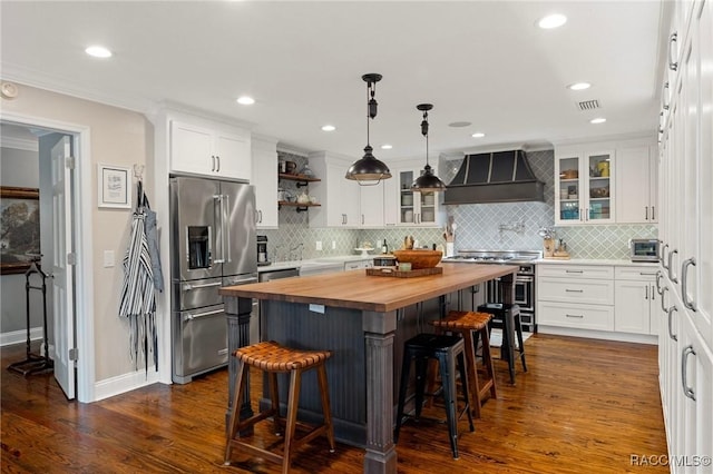 1035 N Appalachian Ter, Crystal River, FL 34429 - kitchen featuring butcher block counters, high quality appliances, wall chimney range hood, white cabinets, and recessed lighting