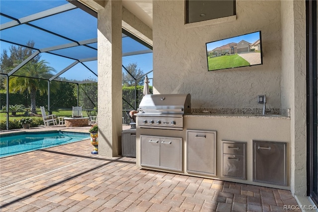 view of patio / terrace featuring area for grilling and a lanai