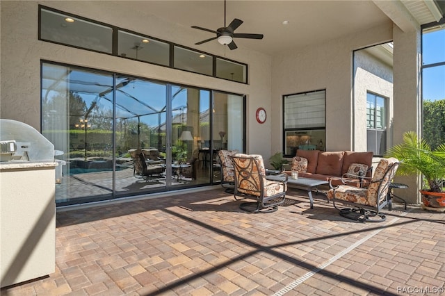 view of patio with ceiling fan, a lanai, and an outdoor hangout area