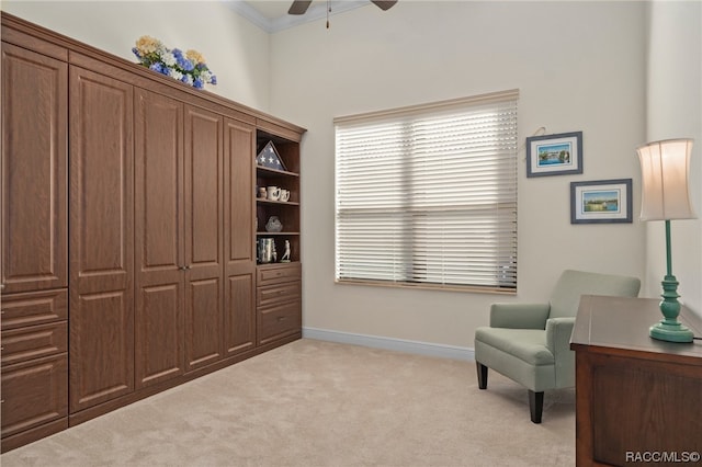 living area featuring light colored carpet, ceiling fan, and crown molding