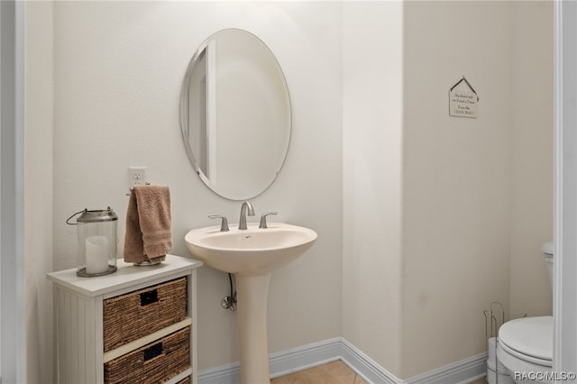 bathroom with sink, tile patterned flooring, and toilet