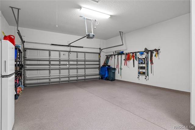 garage with white fridge and a garage door opener