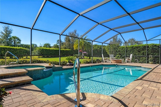 view of pool with glass enclosure, an in ground hot tub, and a patio area