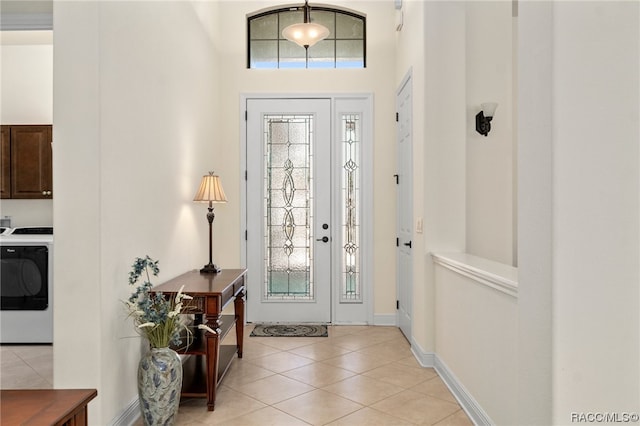 tiled entrance foyer featuring washer / dryer