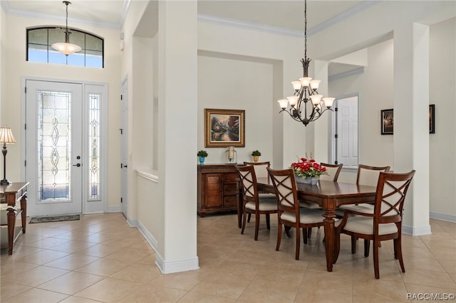 tiled dining space featuring an inviting chandelier and ornamental molding