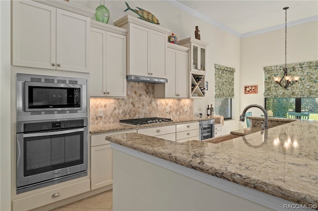 kitchen featuring pendant lighting, stainless steel appliances, wine cooler, and white cabinetry