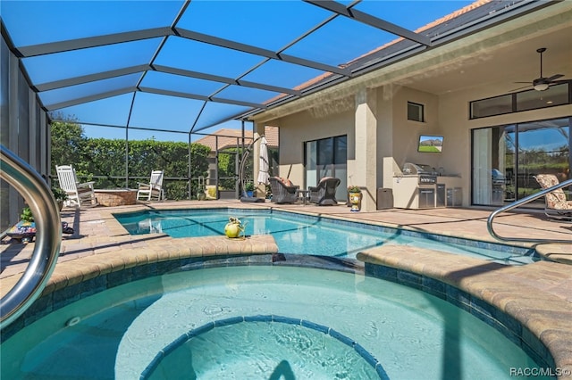 view of swimming pool with an in ground hot tub, area for grilling, ceiling fan, glass enclosure, and a patio