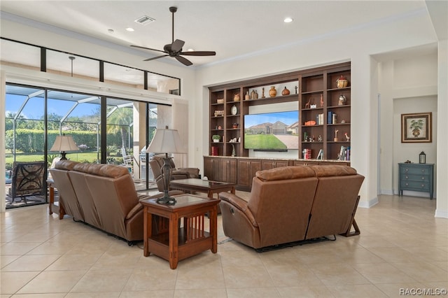 living room with crown molding, built in features, light tile patterned flooring, and ceiling fan