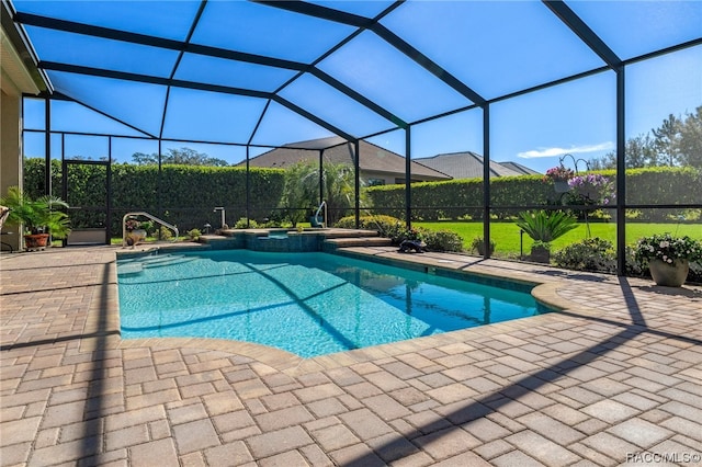 view of swimming pool with a patio and a lanai