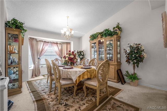 dining space featuring baseboards, light carpet, vaulted ceiling, and a chandelier
