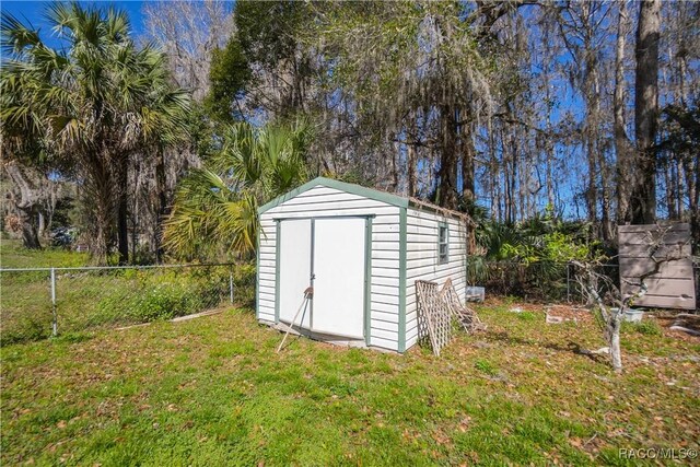 view of shed with fence