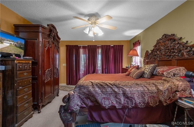 bedroom with ceiling fan and light colored carpet