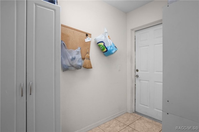 entryway featuring light tile patterned flooring and baseboards