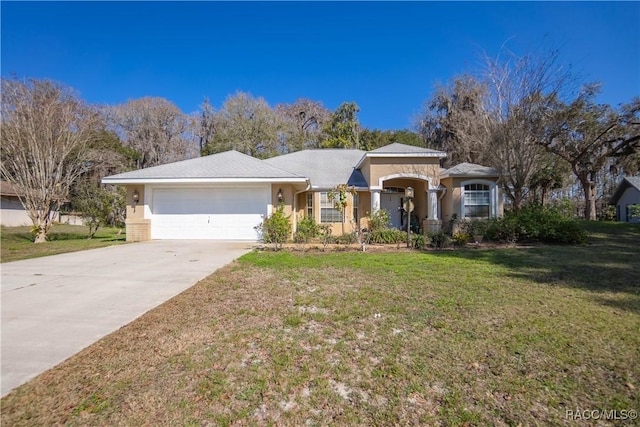 single story home with concrete driveway, stucco siding, a front yard, and a garage