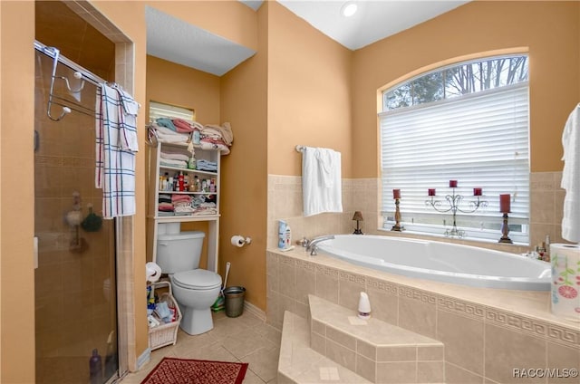 full bath with tile patterned flooring, a shower stall, toilet, and a bath