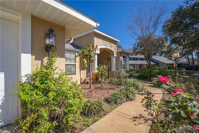property entrance featuring stucco siding