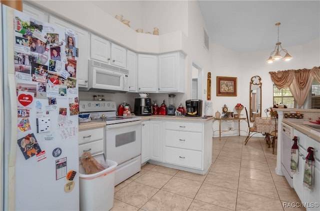 kitchen with white appliances, light countertops, white cabinetry, decorative light fixtures, and light tile patterned floors