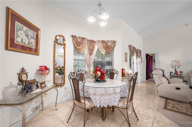 dining space featuring a chandelier and vaulted ceiling