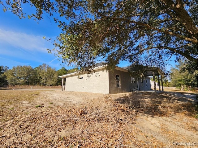 view of side of home with stucco siding