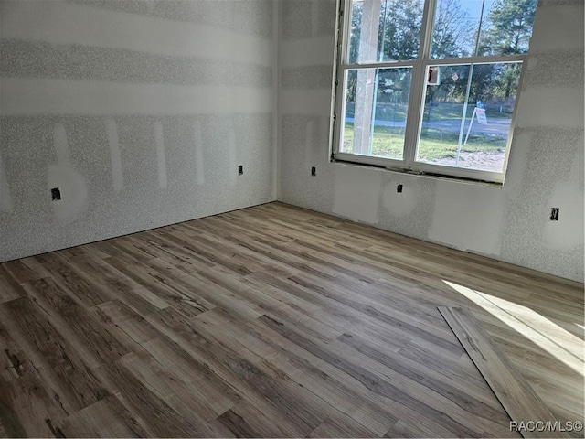 unfurnished room with wood finished floors