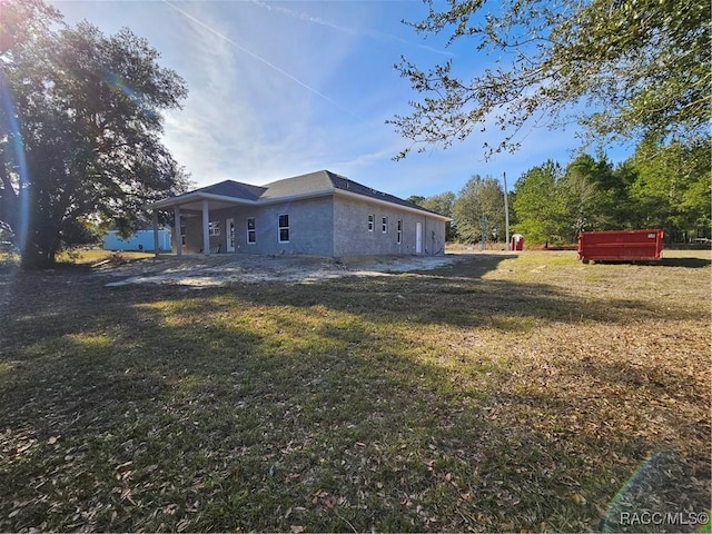 back of property with a lawn