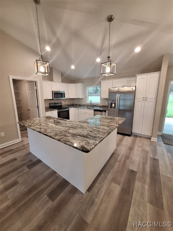 kitchen featuring pendant lighting, white cabinets, and stainless steel appliances