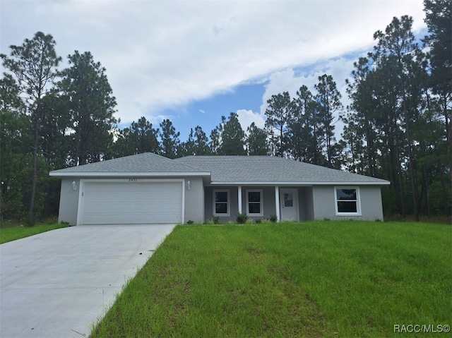 ranch-style home featuring a garage and a front lawn