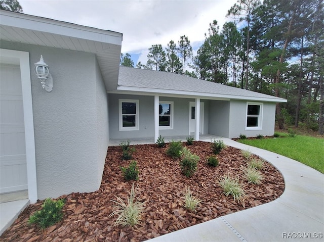 view of front of home featuring covered porch and a garage