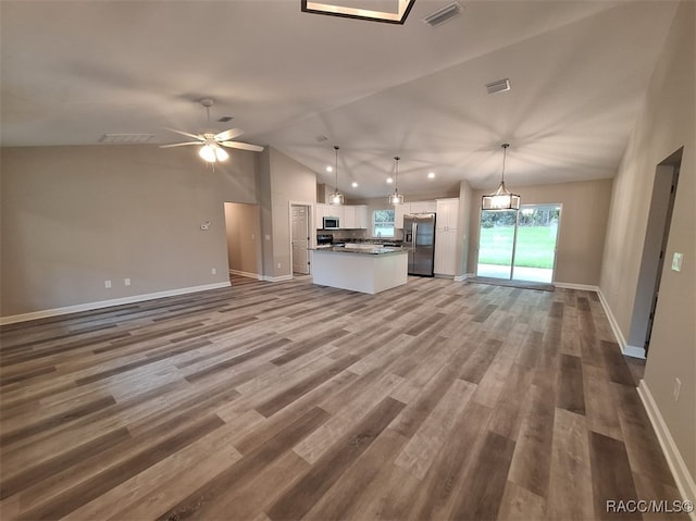 unfurnished living room with wood-type flooring, ceiling fan, and lofted ceiling