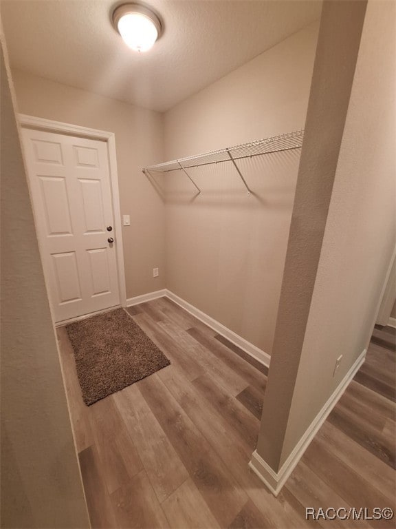 clothes washing area featuring wood-type flooring