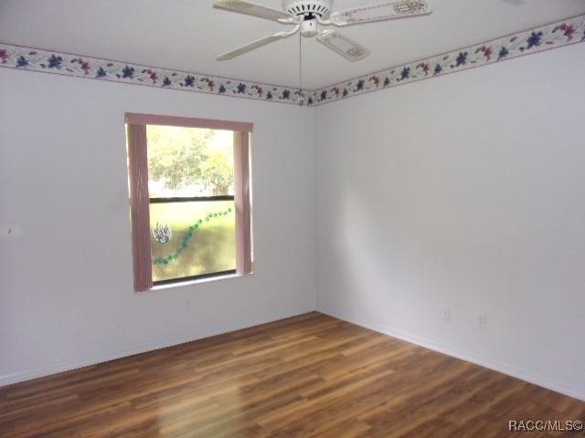 6337 W Lexington Dr, Crystal River, FL 34429 - unfurnished room featuring wood finished floors and a ceiling fan