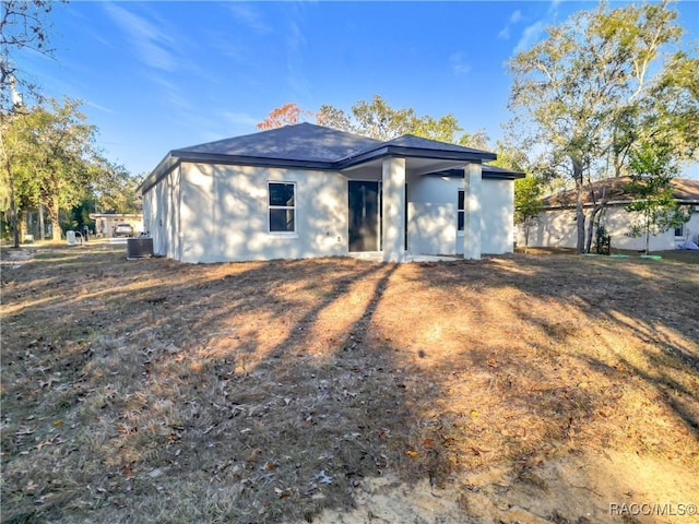 back of house featuring central air condition unit