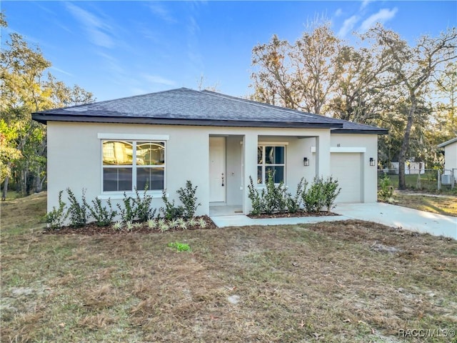 view of front of house with a garage and a front yard