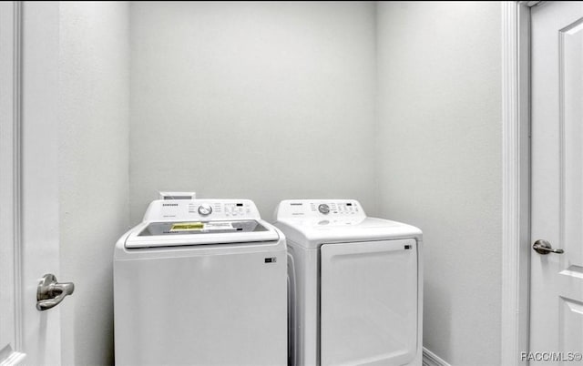 clothes washing area with washing machine and clothes dryer