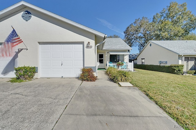 single story home with a front yard, a porch, and a garage