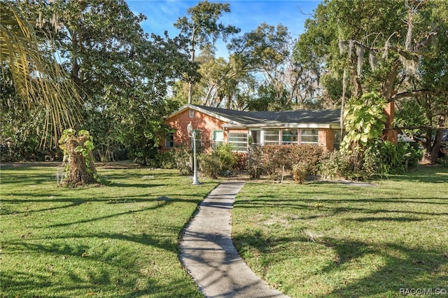 ranch-style home with a front lawn