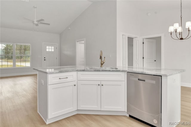 kitchen featuring dishwasher, white cabinets, ceiling fan with notable chandelier, decorative light fixtures, and light hardwood / wood-style floors