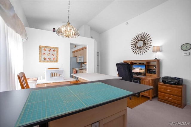 office space featuring an inviting chandelier, vaulted ceiling, and light colored carpet