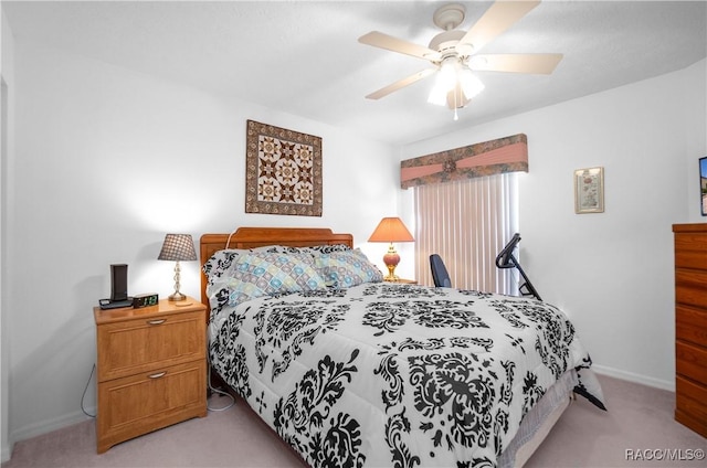 bedroom with ceiling fan and light carpet