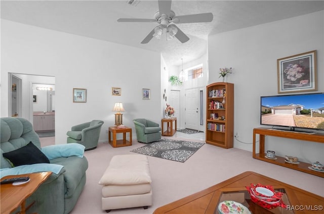 living room featuring carpet floors and ceiling fan