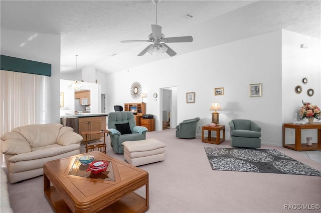 carpeted living room with lofted ceiling, a textured ceiling, and ceiling fan