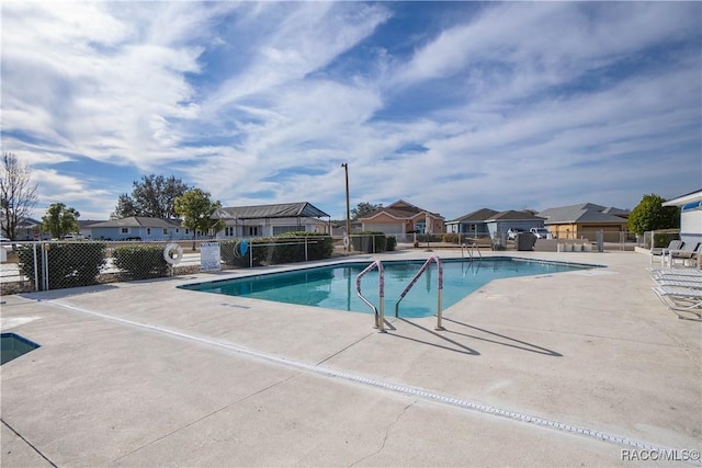 view of swimming pool with a patio