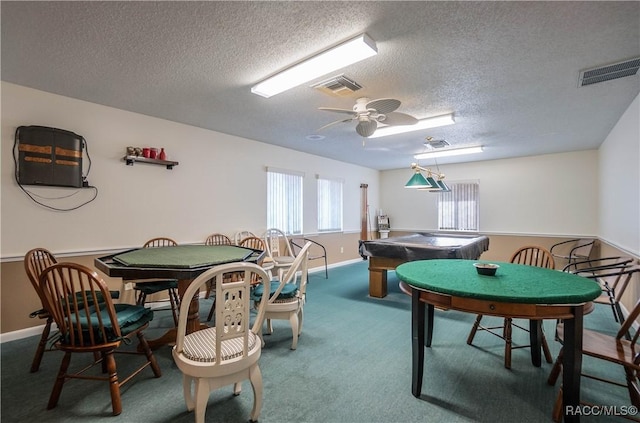 recreation room featuring a textured ceiling, carpet floors, and ceiling fan