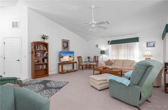 carpeted living room with ceiling fan and high vaulted ceiling