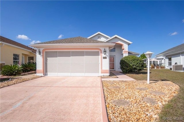 view of front of property with a garage and central AC unit