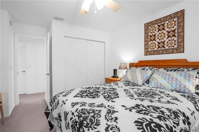 carpeted bedroom featuring a closet and ceiling fan