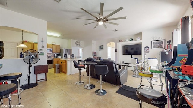 tiled living room featuring ceiling fan